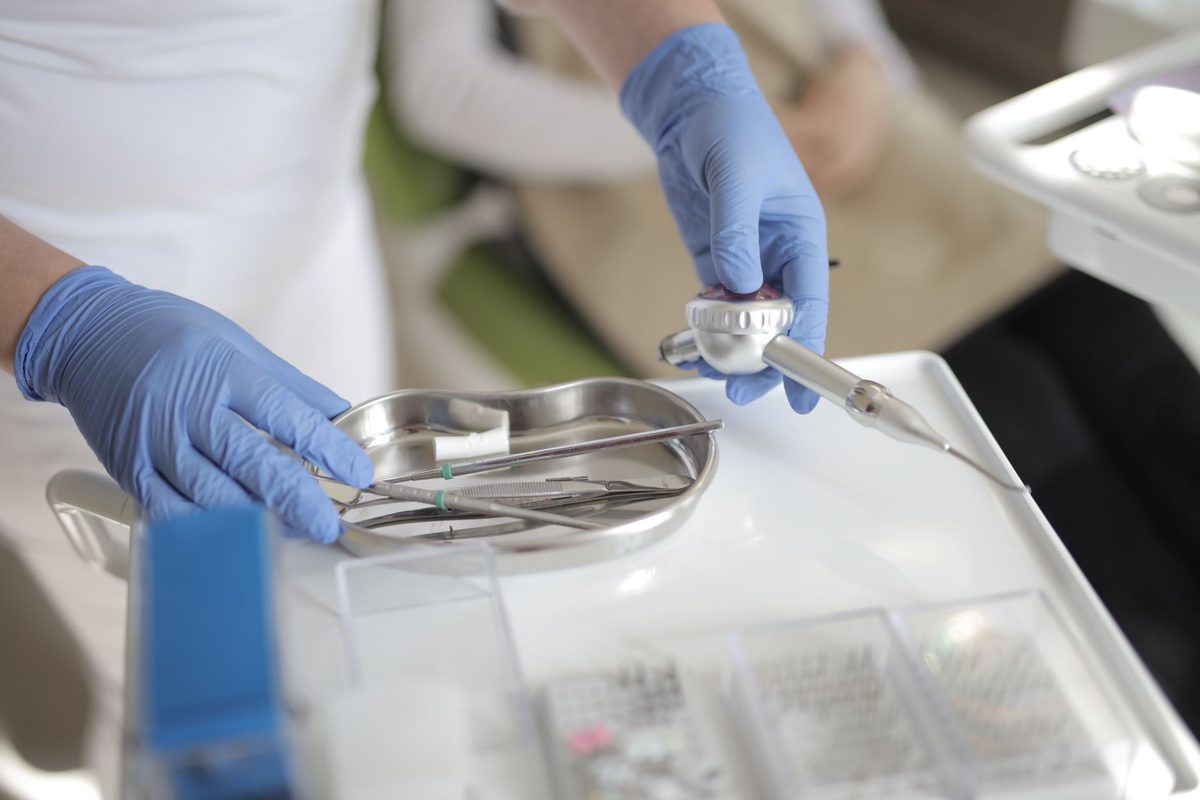 A clinician preparing sterile dental instruments