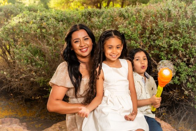 A Spanish-speaking family together outdoors
