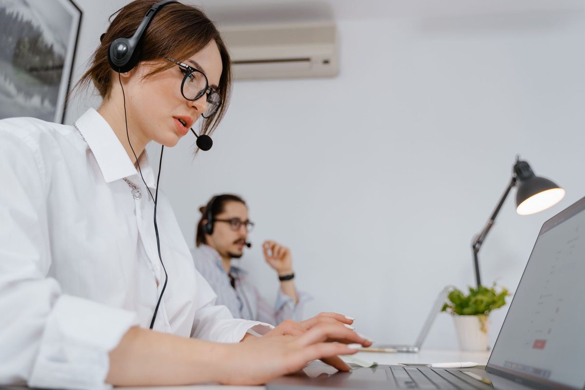 Front-office staff working at computers with headsets